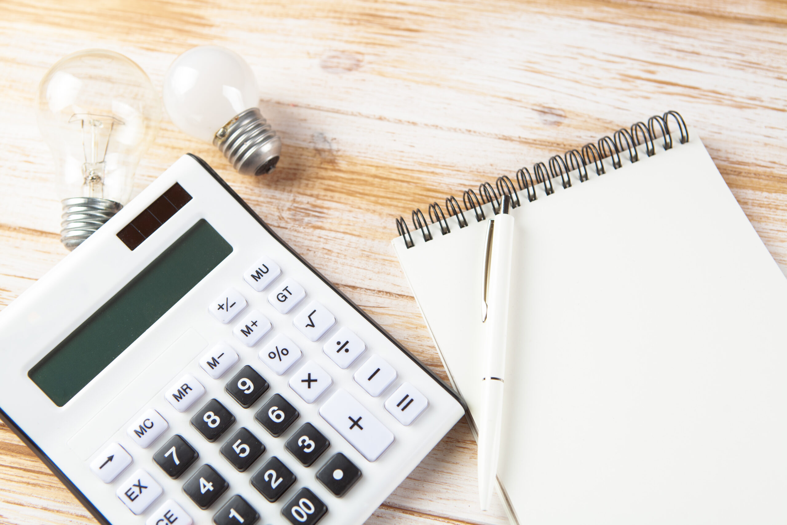 notepad, calculator and light bulbs