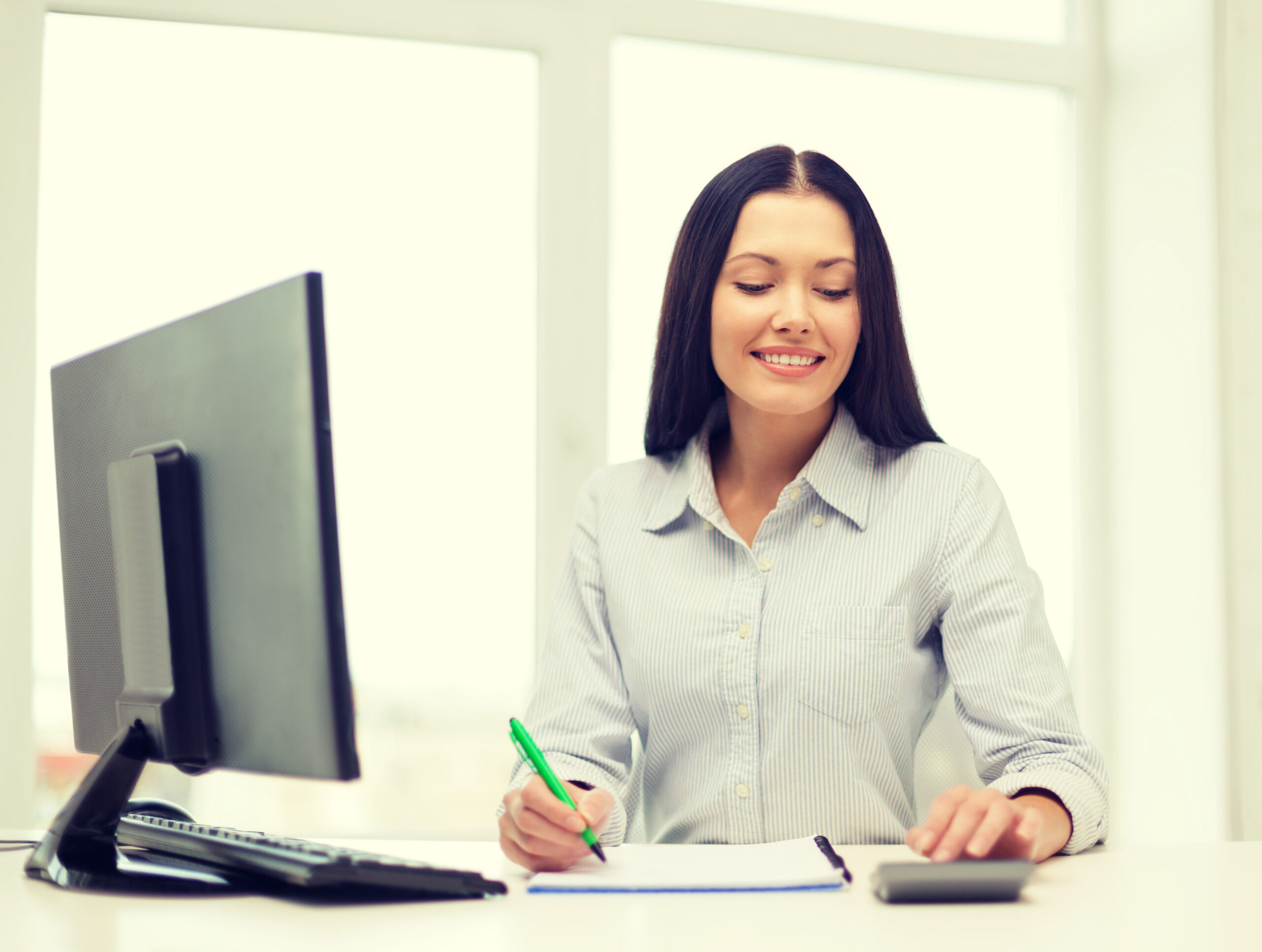 woman with computer, notebook and calculator