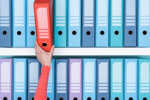 Office worker taking a folder in the archive