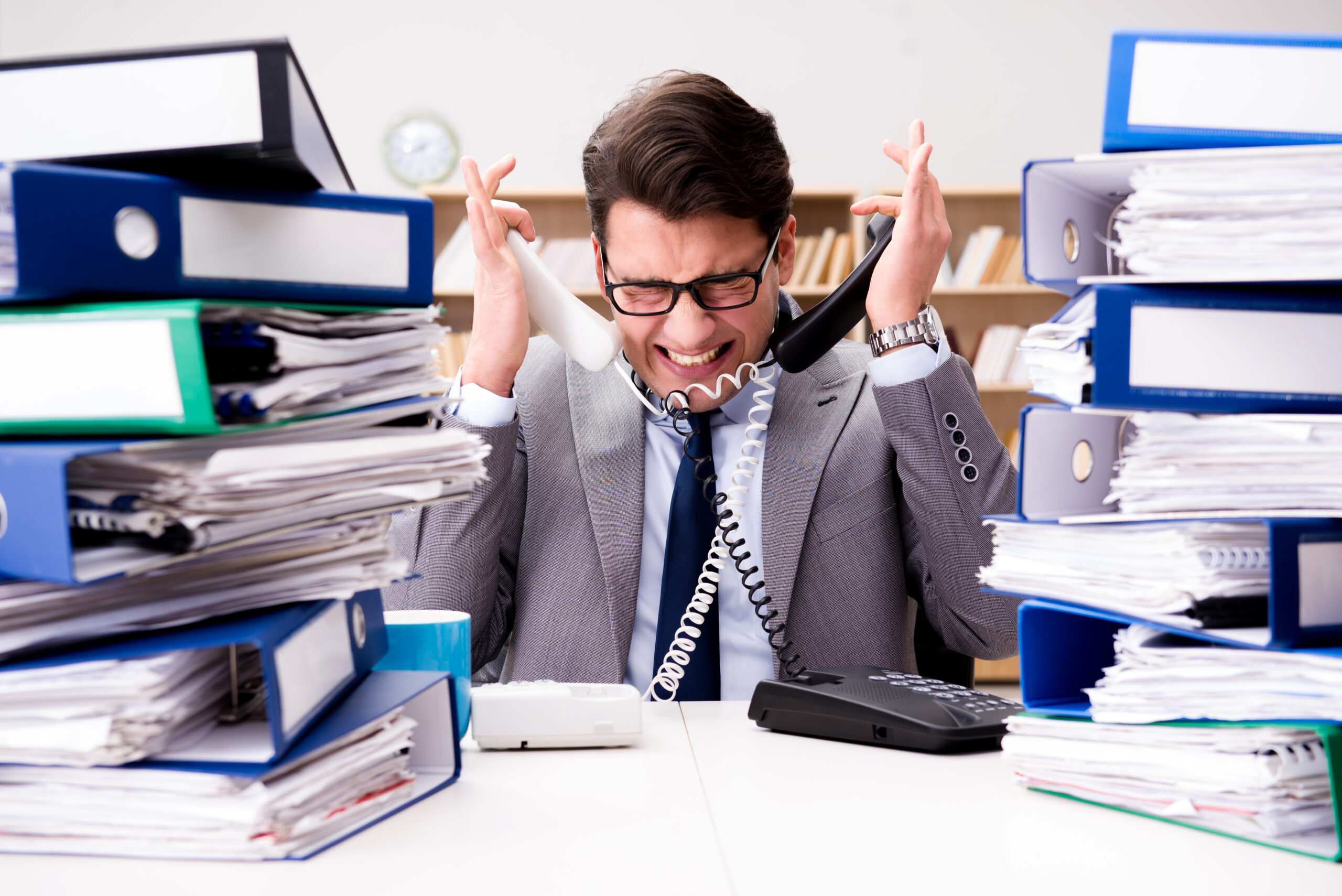 Busy businessman under stress due to excessive work