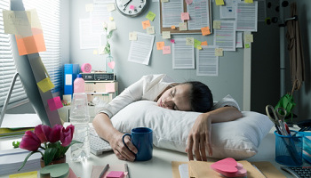 Tired businesswoman waking up in office